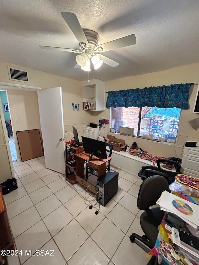 office area featuring a textured ceiling, light tile patterned floors, and ceiling fan