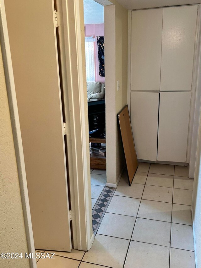 corridor featuring light tile patterned flooring