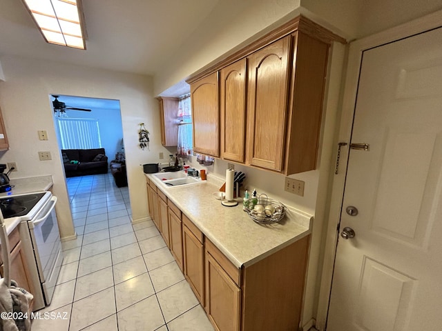 kitchen with sink, electric range, ceiling fan, and light tile patterned floors