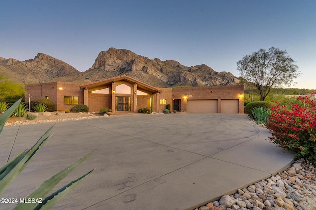 southwest-style home with a mountain view and a garage