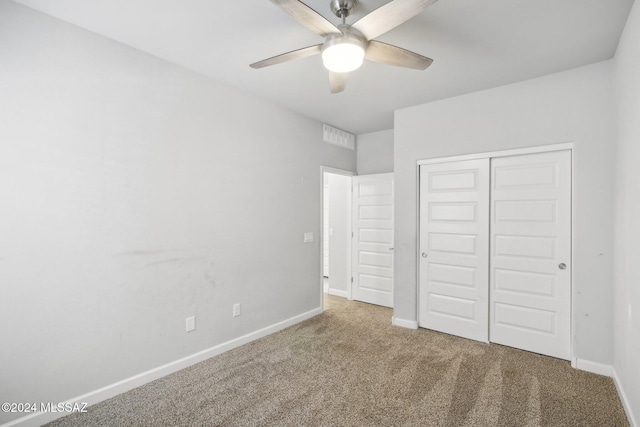 unfurnished bedroom featuring ceiling fan, a closet, and carpet