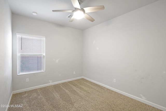 spare room with carpet floors and ceiling fan