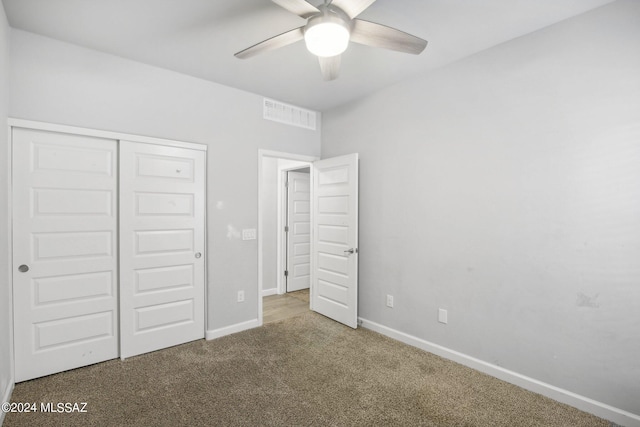 unfurnished bedroom featuring carpet floors, a closet, and ceiling fan