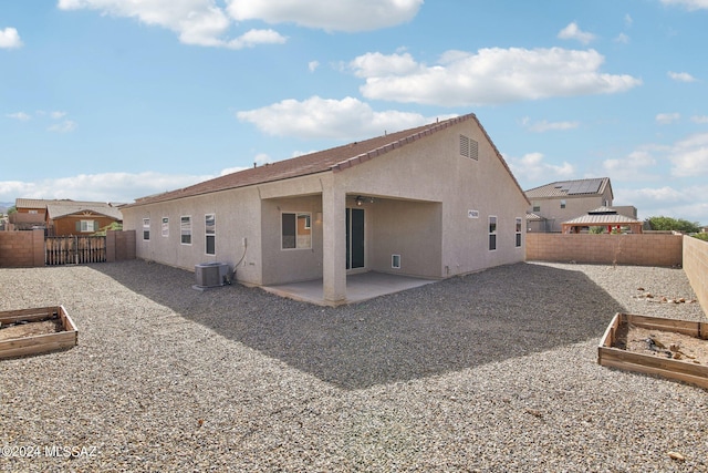 rear view of property featuring central air condition unit, a gazebo, and a patio area