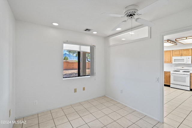 tiled spare room with ceiling fan