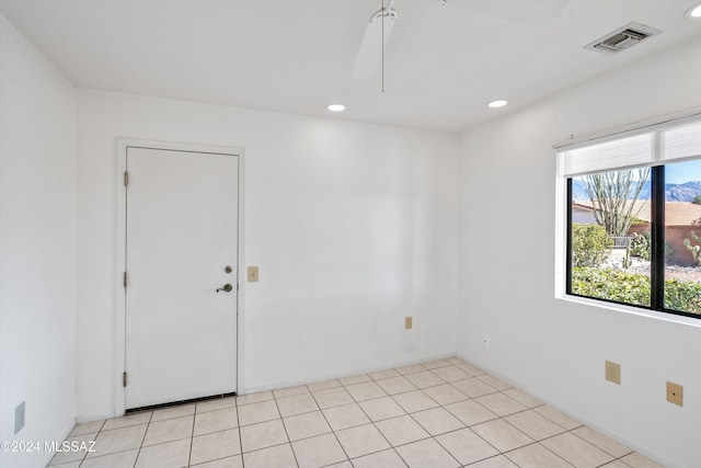 tiled empty room with ceiling fan