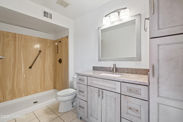 bathroom with vanity, a shower, and toilet