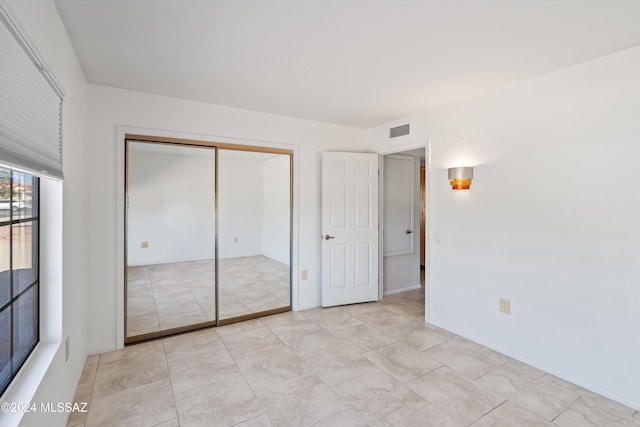 unfurnished bedroom with a closet