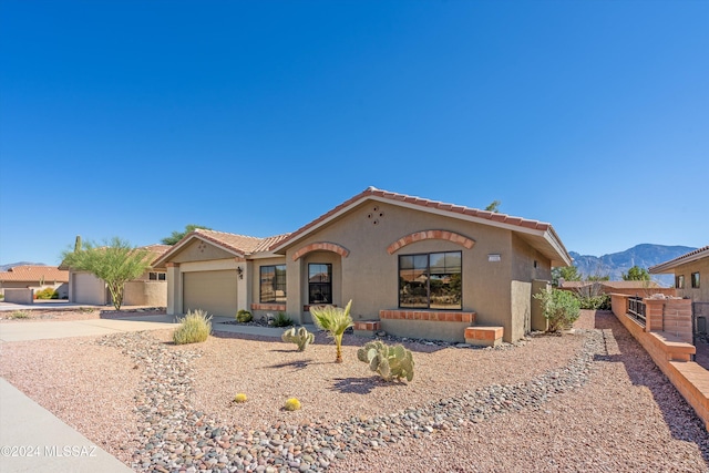 view of front of property featuring a mountain view and a garage