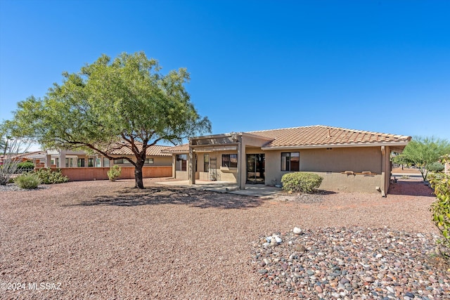 back of property with a patio