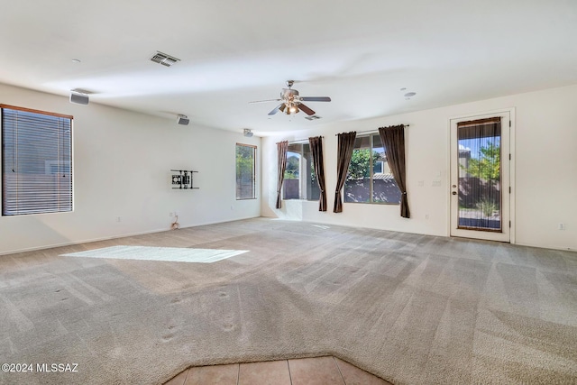 unfurnished room with ceiling fan and light colored carpet