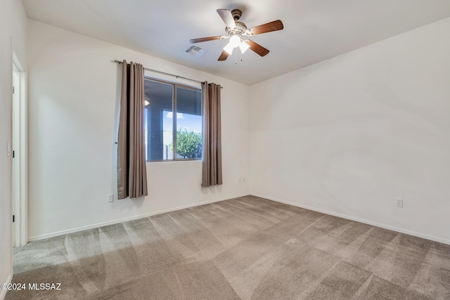 carpeted empty room featuring ceiling fan