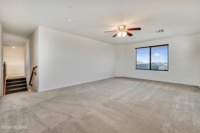 carpeted spare room featuring ceiling fan