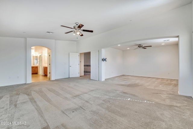 spare room with ceiling fan and light carpet