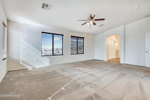 unfurnished living room with ceiling fan and light carpet