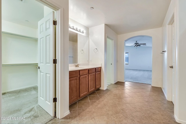 bathroom with ceiling fan and vanity