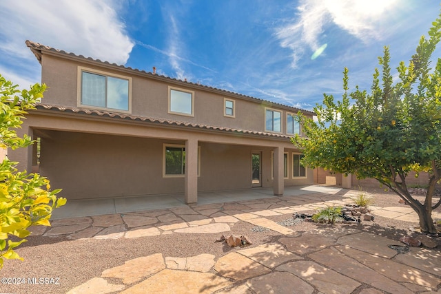 back of property featuring a patio