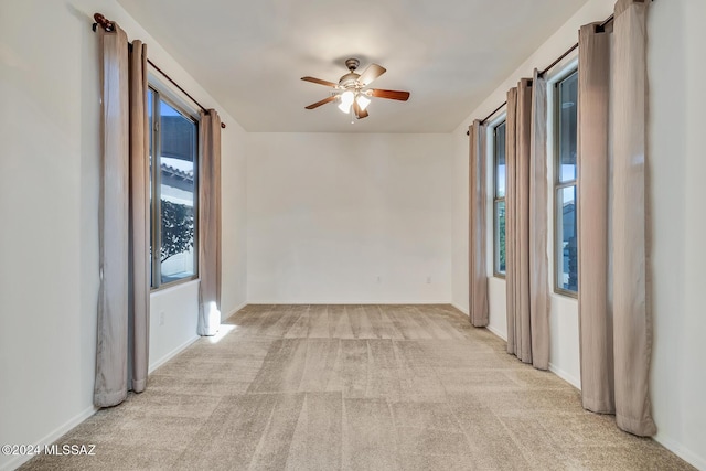 spare room featuring ceiling fan and light carpet