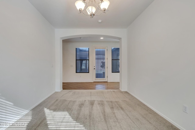 hallway featuring light tile patterned floors and a chandelier