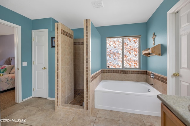 bathroom featuring tile patterned floors, independent shower and bath, and vanity