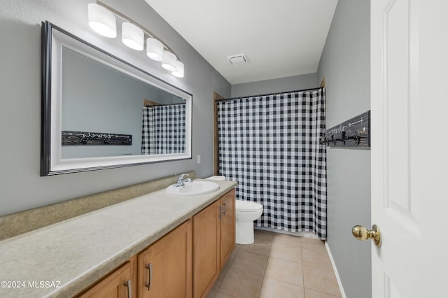 bathroom featuring tile patterned floors, toilet, and vanity