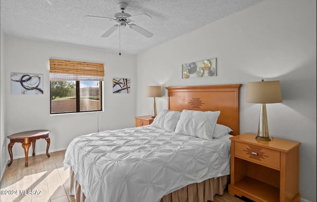 bedroom with light hardwood / wood-style floors, a textured ceiling, and ceiling fan