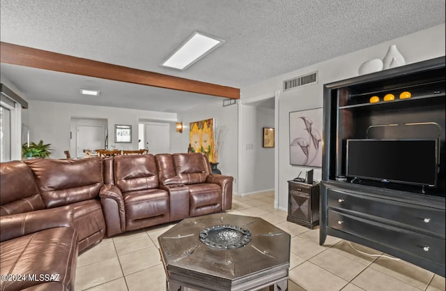 living room featuring beamed ceiling, a textured ceiling, and light tile patterned floors