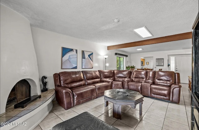 tiled home theater featuring beam ceiling and a textured ceiling