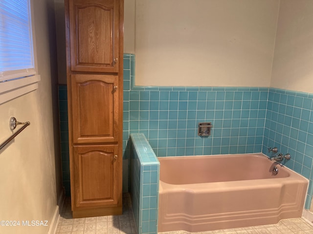 172 S Austin Blvd, Willcox, AZ 85643 - bathroom featuring tile walls, a garden tub, and a wainscoted wall