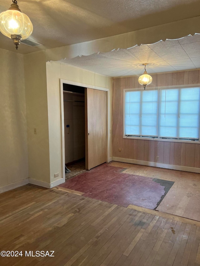 interior space featuring a textured ceiling and hardwood / wood-style flooring