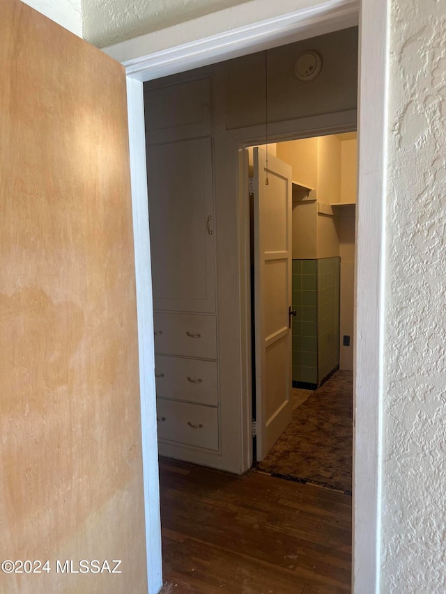 hallway with dark hardwood / wood-style floors