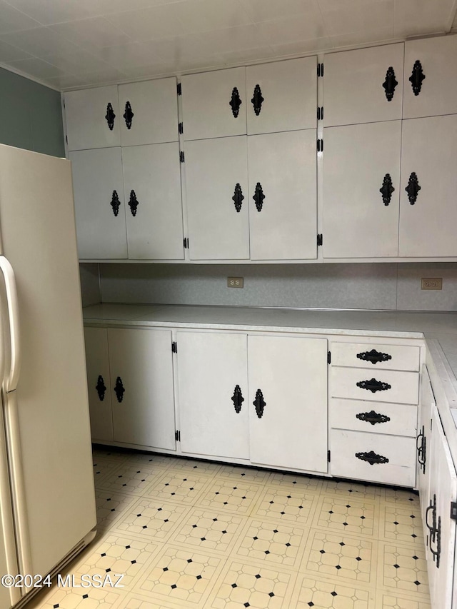 interior space featuring white cabinetry and white refrigerator