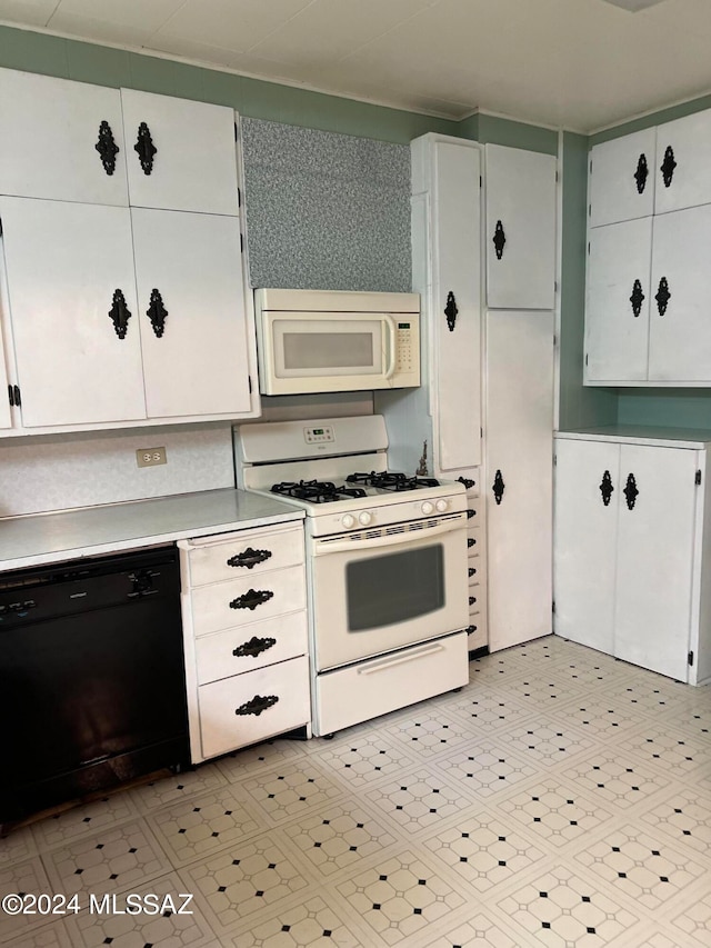 kitchen featuring white cabinets and white appliances