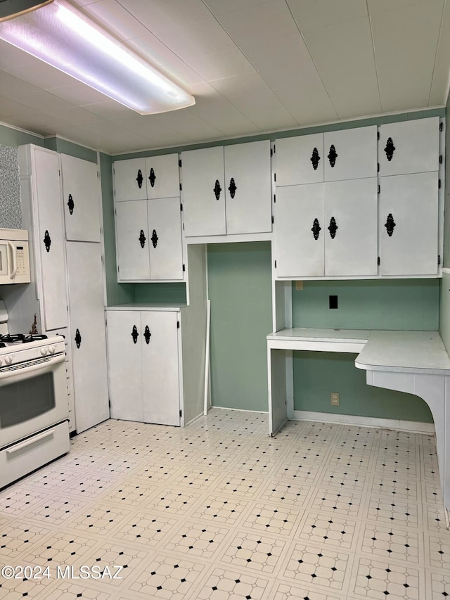 kitchen with white appliances and white cabinets