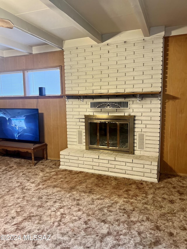 172 S Austin Blvd, Willcox, AZ 85643 - unfurnished living room with beamed ceiling, a fireplace, carpet flooring, and wood walls