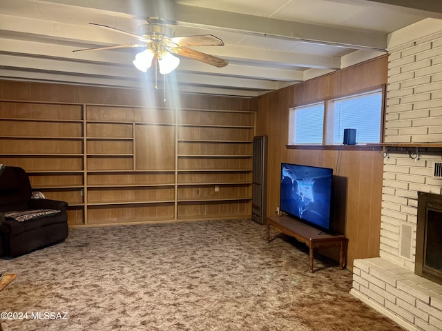 172 S Austin Blvd, Willcox, AZ 85643 - unfurnished living room with carpet floors, a ceiling fan, beam ceiling, and wooden walls