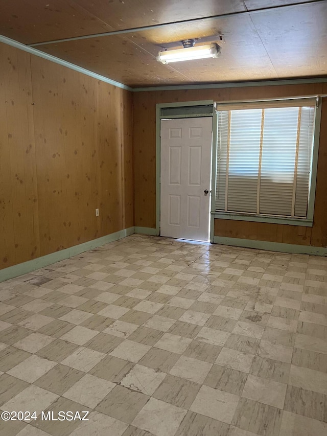 172 S Austin Blvd, Willcox, AZ 85643 - spare room featuring light floors, baseboards, and wood walls