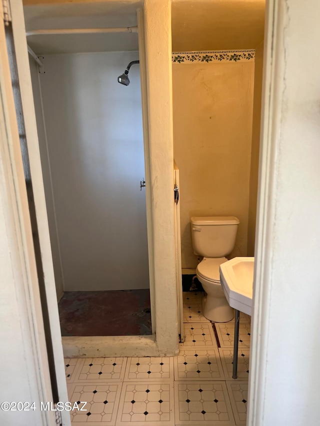 bathroom featuring a shower and toilet