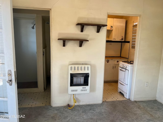 kitchen with heating unit and white range with electric stovetop