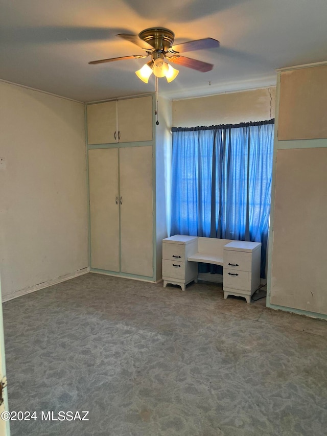 unfurnished bedroom featuring carpet floors, a closet, and ceiling fan