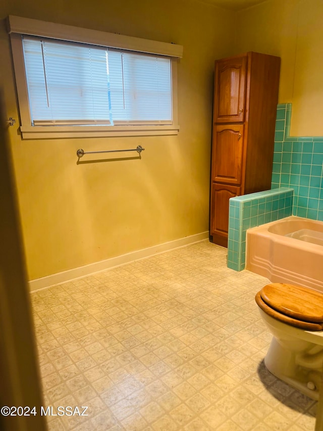 bathroom featuring toilet and a bathing tub