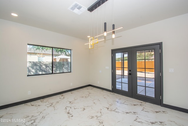 unfurnished room with french doors