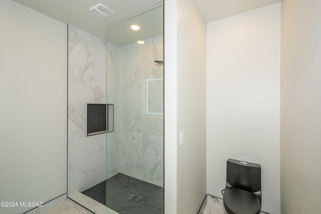bathroom with a tile shower