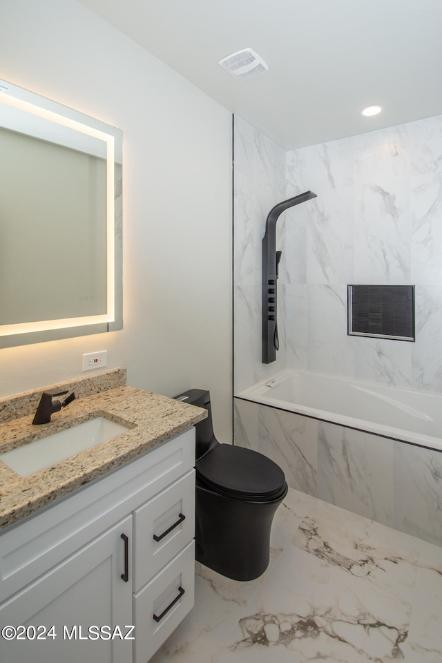 full bathroom featuring tiled shower / bath, vanity, and toilet
