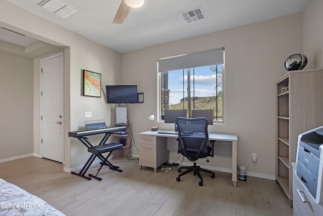 home office featuring light wood-type flooring and ceiling fan