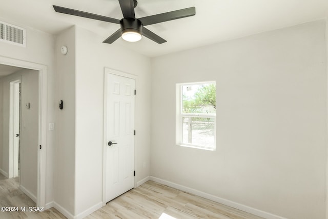 spare room featuring light wood-type flooring and ceiling fan