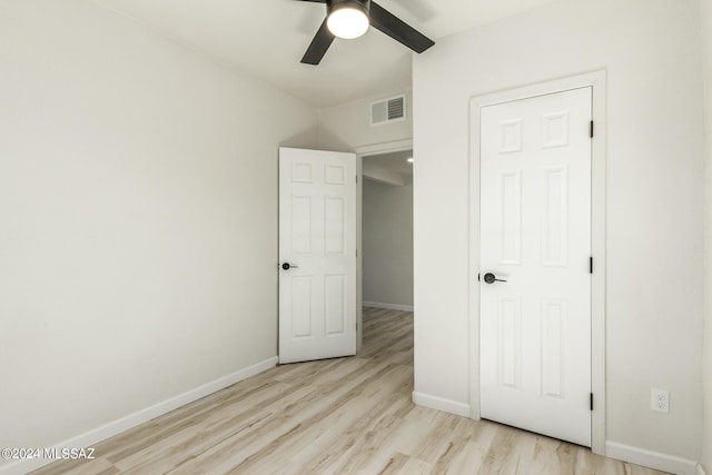 unfurnished bedroom with ceiling fan and light wood-type flooring