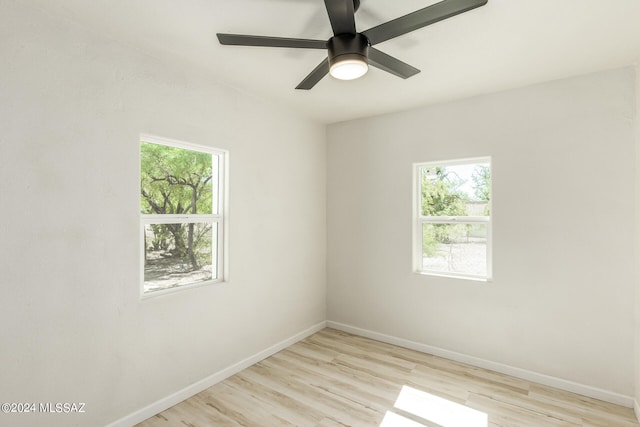 empty room with light wood-type flooring, a wealth of natural light, and ceiling fan