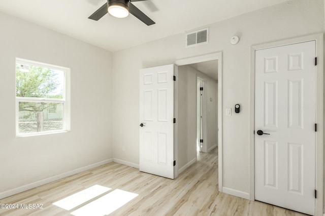 unfurnished bedroom with ceiling fan and light hardwood / wood-style floors