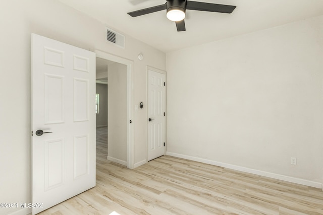 empty room featuring ceiling fan and light hardwood / wood-style floors